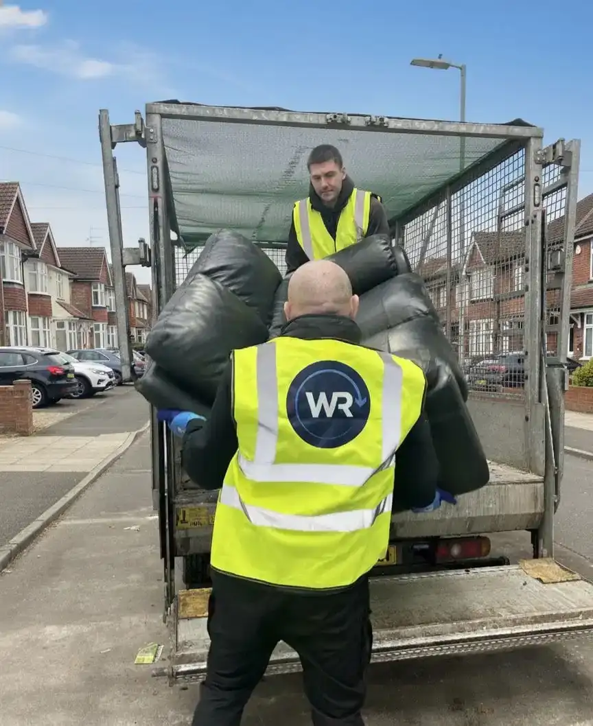 Uniformed team loading waste into van in the North West