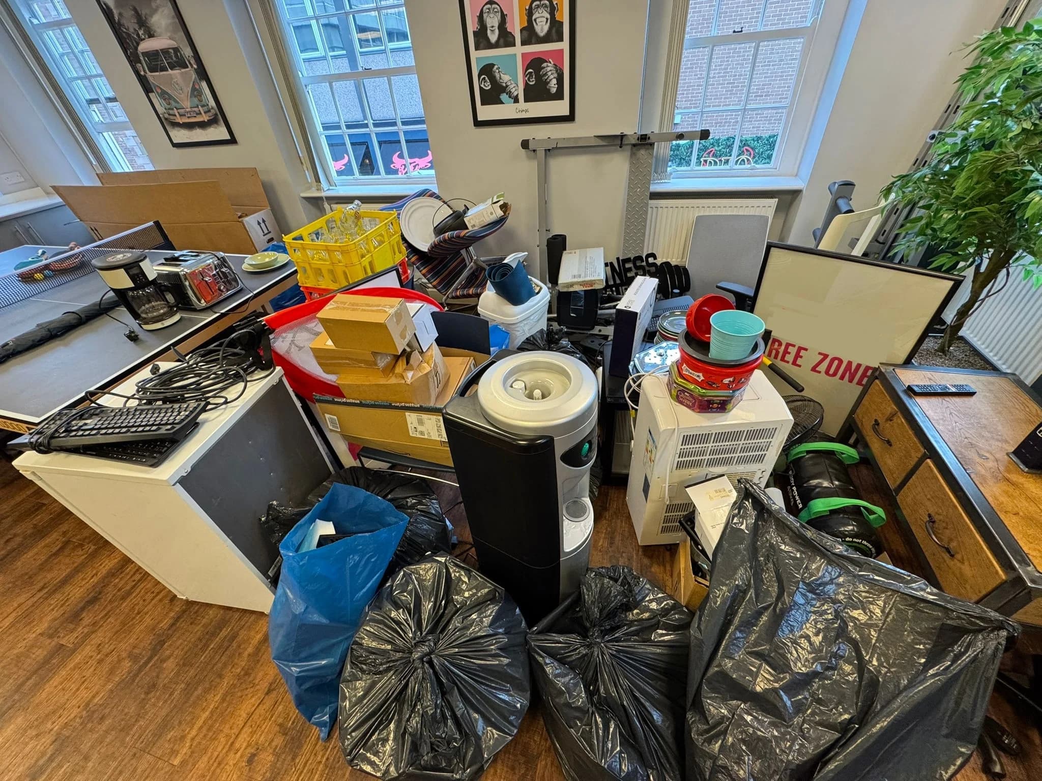 Office clearance before clearance showing office furniture and items